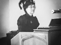 JoAnne Jones in Victorian garb at the keyboard