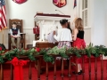 Children placing figures in the creche