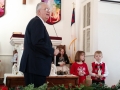 The children bring the manger scene figures forward