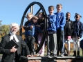 "John Wesley" poses with children by the church's old bell