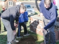 Harrison Griffin and Jonathan Griffin finish filling the hole