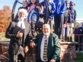 Pastor Kelvin Jones in front of the bell with "John Wesley" and the children