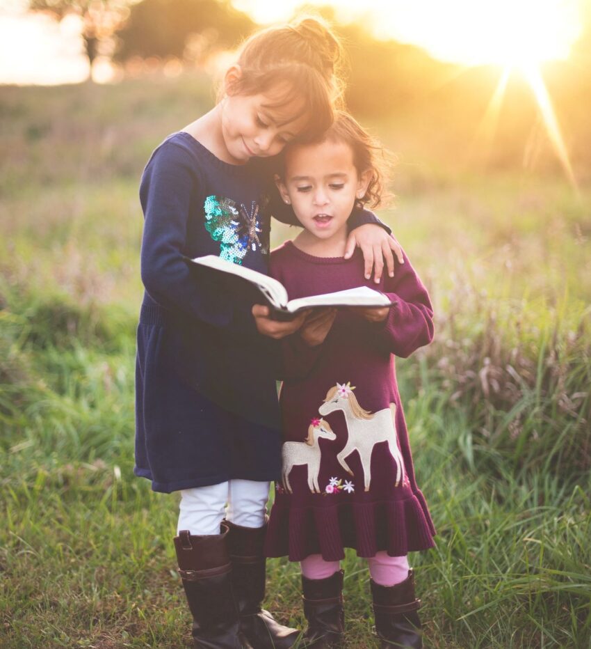 two girls reading Bible